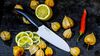 
                    Kyocera Santoku cutting an orange